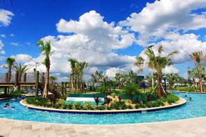 A swimming pool surrounded by palm trees and a clear blue sky. - Lake-view Near Disney Resort w Lazy River 108 3151 (Kissimmee)