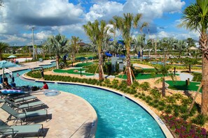 A swimming pool with lounge chairs and palm trees. - Lake-view Near Disney Resort w Lazy River 108 3151 (Kissimmee)