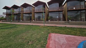 A modern building with multiple balconies and large windows. - SHYAM RESORT (Khandwa)