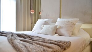 A neatly made bed with a textured blanket, white pillows, and a cream-colored headboard. - 3 bedrooms apartment in secure Résidence (Casablanca)
