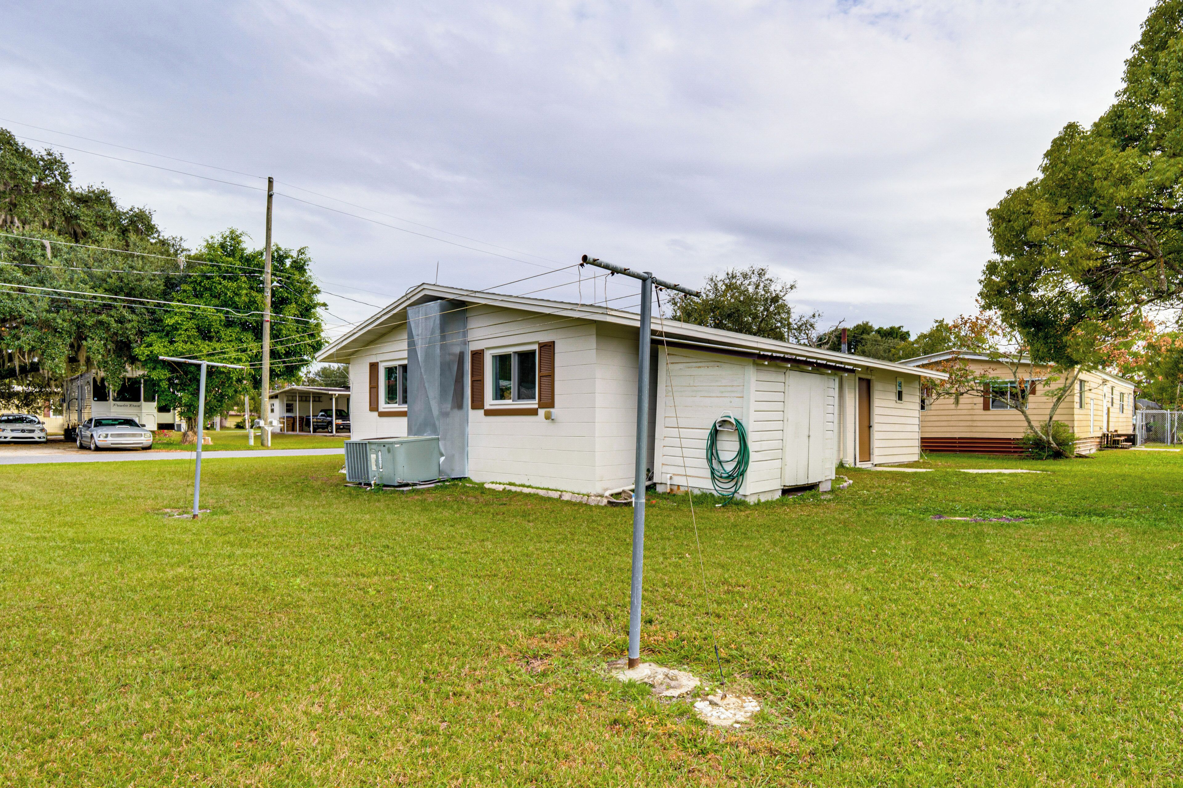 A single-story house with a front porch, a garage, and a small yard.