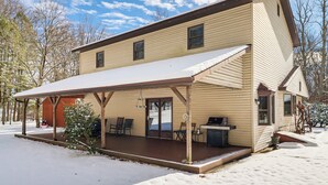 A two-story building with a covered porch, a grill, and a snow-covered ground. - 4 Mi to Camelback! Group-friendly Poconos Cabin (Tannersville)