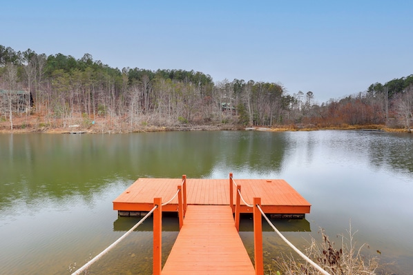 A wooden dock extending into a calm lake, surrounded by trees and a clear sky. - Great for Groups! Quiet Nebo Cabin w/ Lake Access (Nebo)