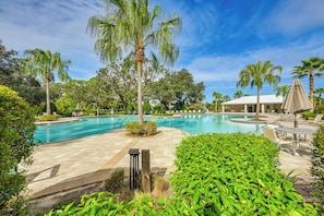 A swimming pool surrounded by palm trees and lounge chairs. - Florida Snowbird Haven w/ Pool! Easy I-75 Access (Parrish)