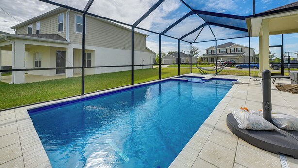 A swimming pool with a clear view of houses in the background. - Florida Snowbird Haven w/ Pool! Easy I-75 Access (Parrish)