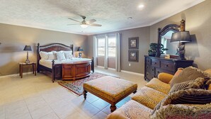 A bedroom with a bed, a nightstand, a dresser, a chair, and a ceiling fan. - 7 Mi to Paynes Prairie Preserve! Rural Retreat (Micanopy)