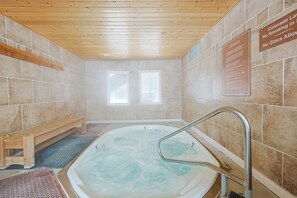 A spa room with a wooden ceiling, a hot tub, and two windows. - Wild Irishman 2 bed 1.5 bath deluxe On Shuttle Route Close to Everything! (Keystone)