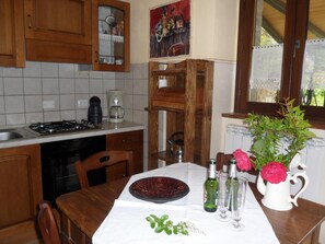 Een koelkast, een oven, kookgerei, borden en bestek