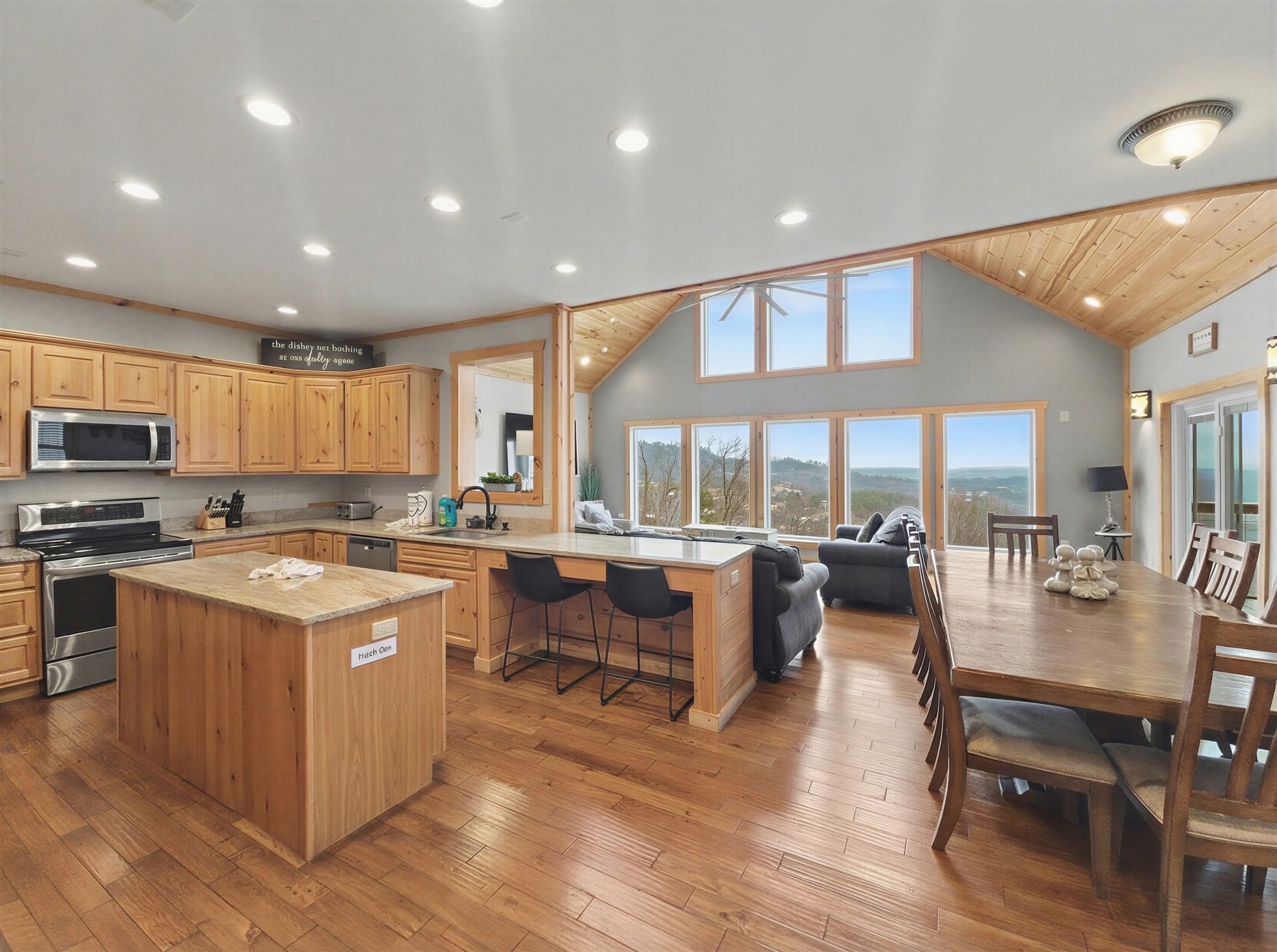 A spacious kitchen with wooden cabinets, a central island, and a dining area with a view.