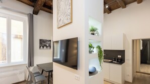 A modern kitchen with white cabinets, a built-in oven, and a countertop with a sink. - Rental in Rome Navona Modern Apartment (Rome)