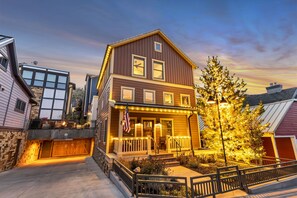 A two-story house with a porch, a small deck, and a garage. - The Peak At Town Lift 3 Bedroom Home (Park City)