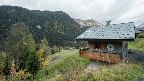 A rustic mountain cabin with a stone foundation, wooden balcony, and a metal roof. - Charming Chalet for 5 Guests in Châtel (Châtel)