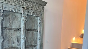 A staircase with a wooden door featuring intricate carvings and a metal handle. - Sunrise Villa Sea View up to 4 pax (Ano Mera)