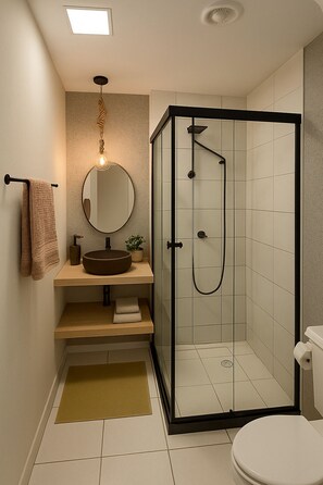 A modern bathroom with a glass-enclosed shower, a round mirror, a beige sink, and a toilet. - Comfort in the heart of São Paulo (São Paulo)