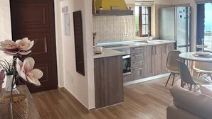 A modern kitchen with a central island, wooden cabinets, and a yellow accent wall. - Peaceful Sea View Holiday Home with Stunning Sunsets". (Los Llanos De Aridane)