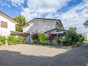 A residential building with a paved driveway, a garage, and a small porch area. - Villa für 6 Personen ca. 50qm Stella Marina 14 A by Interhome (Bibione)