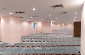 A large, empty hotel room with a carpeted floor, a staircase, and a door. - BARADIS LAND HOTEL (Makkah)