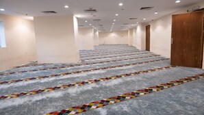 A long, narrow hotel corridor with carpeted stairs leading to a door at the end. - BARADIS LAND HOTEL (Makkah)