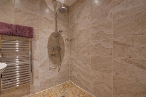 A bathroom with a shower, a towel rack, and a tiled floor. - 2 Bed in Staithes (oc-wa022) (Easington)