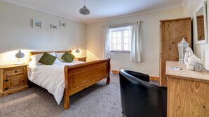 A bedroom with a wooden bed, bedside lamps, a desk with a chair, a window with curtains, and a wardrobe. - 2 Bed in Y Felinheli (oc-wag431) (Y Felinheli)