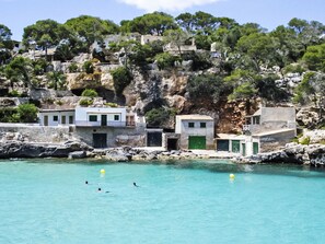 A coastal area with buildings near the water, rocky cliffs, and trees. - Casa Poggibonsi Mar by Interhome (Llombards/C.Llombards/C.S'Almonia)