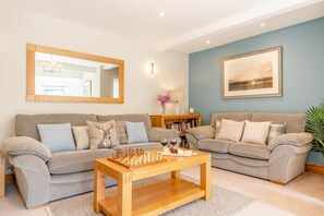 A living room with two sofas, a coffee table, a chessboard, and a framed picture on the wall. - 3 Bed in Gunnerside (oc-ds097) (Gunnerside)