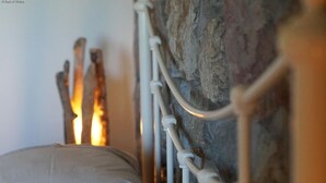A bed with a white pillow against a stone wall and a metal headboard. - 9 Bed in Pwllheli (oc-387040) (Pwllheli)