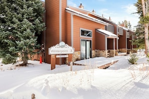 A two-story building with a sign reading "Winterpoint II" and a stone facade. - Newly Remodeled; Great Location; Heated Garage (Breckenridge)