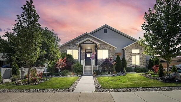 A two-story house with a front porch, a driveway, and a well-maintained lawn. - Cozy & Comfy Mountain-View Home Airport 15 min (West Valley City)
