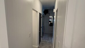 A narrow hallway with carpeted floors and white walls. - Cozy & Comfy Mountain-View Home Airport 15 min (West Valley City)