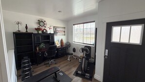 A home gym with a bench, dumbbells, and exercise equipment. - Cozy & Comfy Mountain-View Home Airport 15 min (West Valley City)
