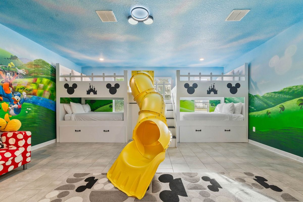 Bedroom 1 with 4 double beds. A whimsical Mickey-themed paradise for kids to laugh, play, and sleep.