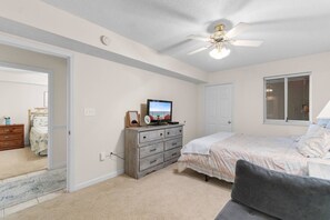 A bedroom with a bed, a dresser, a television, a ceiling fan, and a window. - 3 Bdrm North Shore Villa w/ Lazy River, Hot Tub (North Myrtle Beach)
