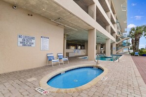 An indoor swimming pool with a lifeguard sign, lounge chairs, and a pool rules sign. - 3 Bdrm North Shore Villa w/ Lazy River, Hot Tub (North Myrtle Beach)