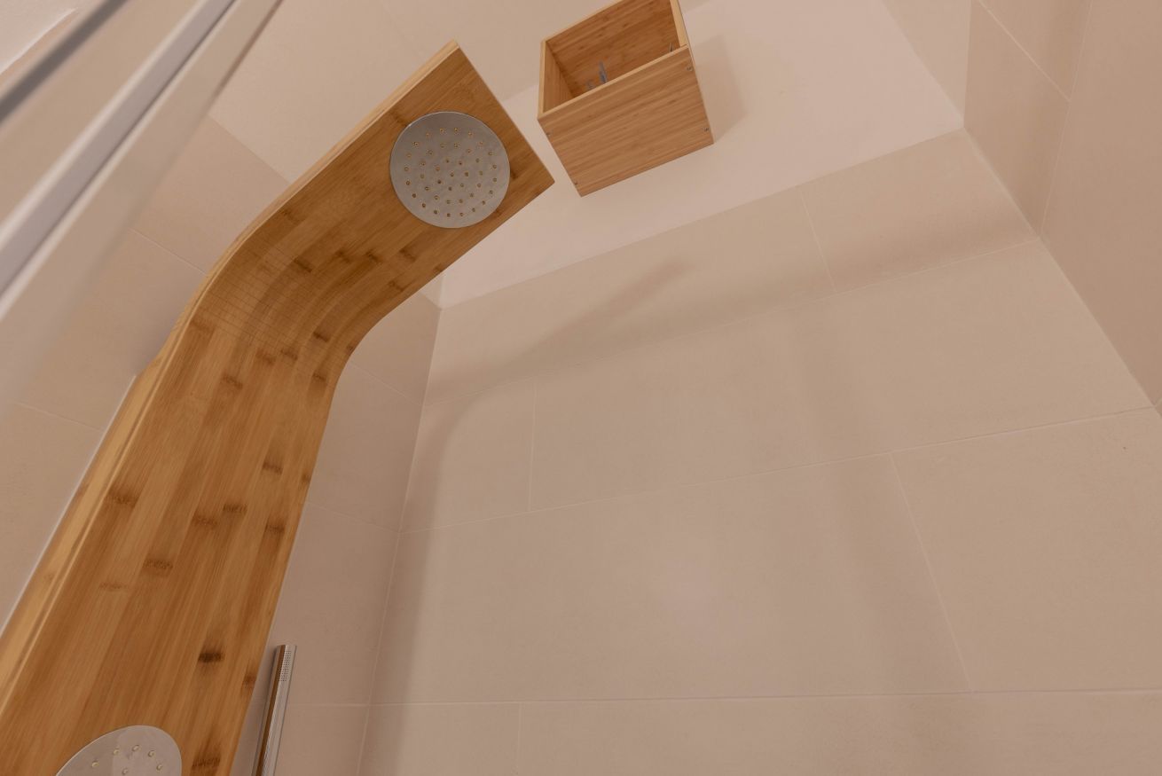 A corner of a room with a wooden structure, a white wall, and a small wooden box.