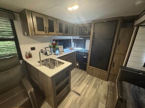 Fridge, microwave, oven, stovetop - Indian Creek Farms Poolside Camper (Oglethorpe County)