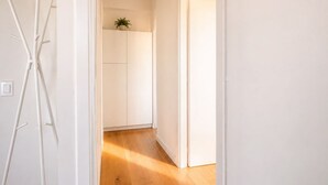 A hallway with a wooden floor and white walls. - GuestHost - Cozy and modern 70 sqm apartment, able to comfortably accommodate up to 6 people, located on the 5th floor of a modern building with lift (NOT suitable for disabled people). The property is located in an extremely strategic area, just 400 met (Florence)