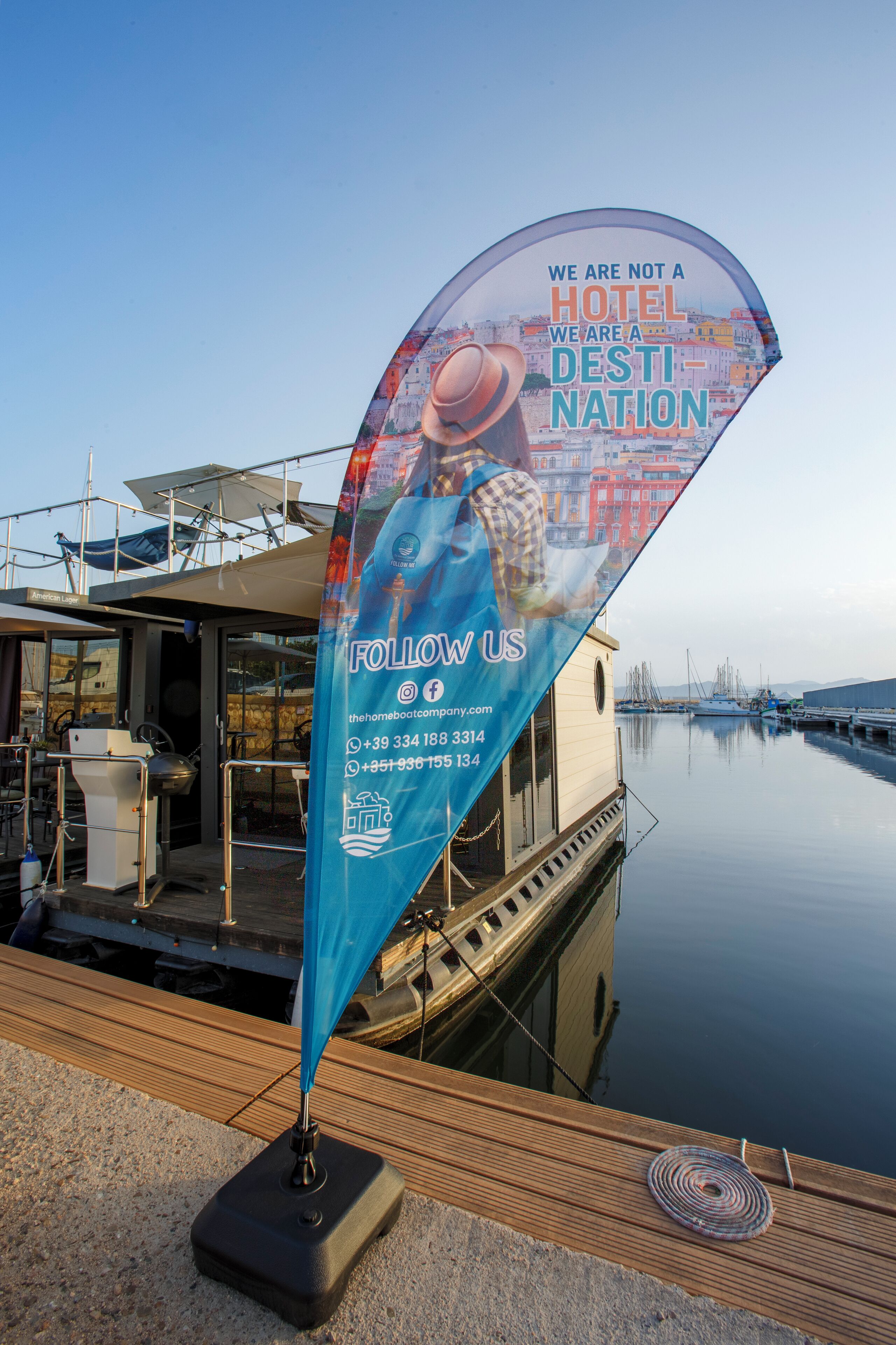 A floating hotel with a clear view of the water and boats in the background.