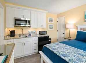 A compact bedroom with a bed, a desk, a kitchenette, and a bathroom. - Casa Bella D in Fort Myers Beach (Fort Myers Beach)