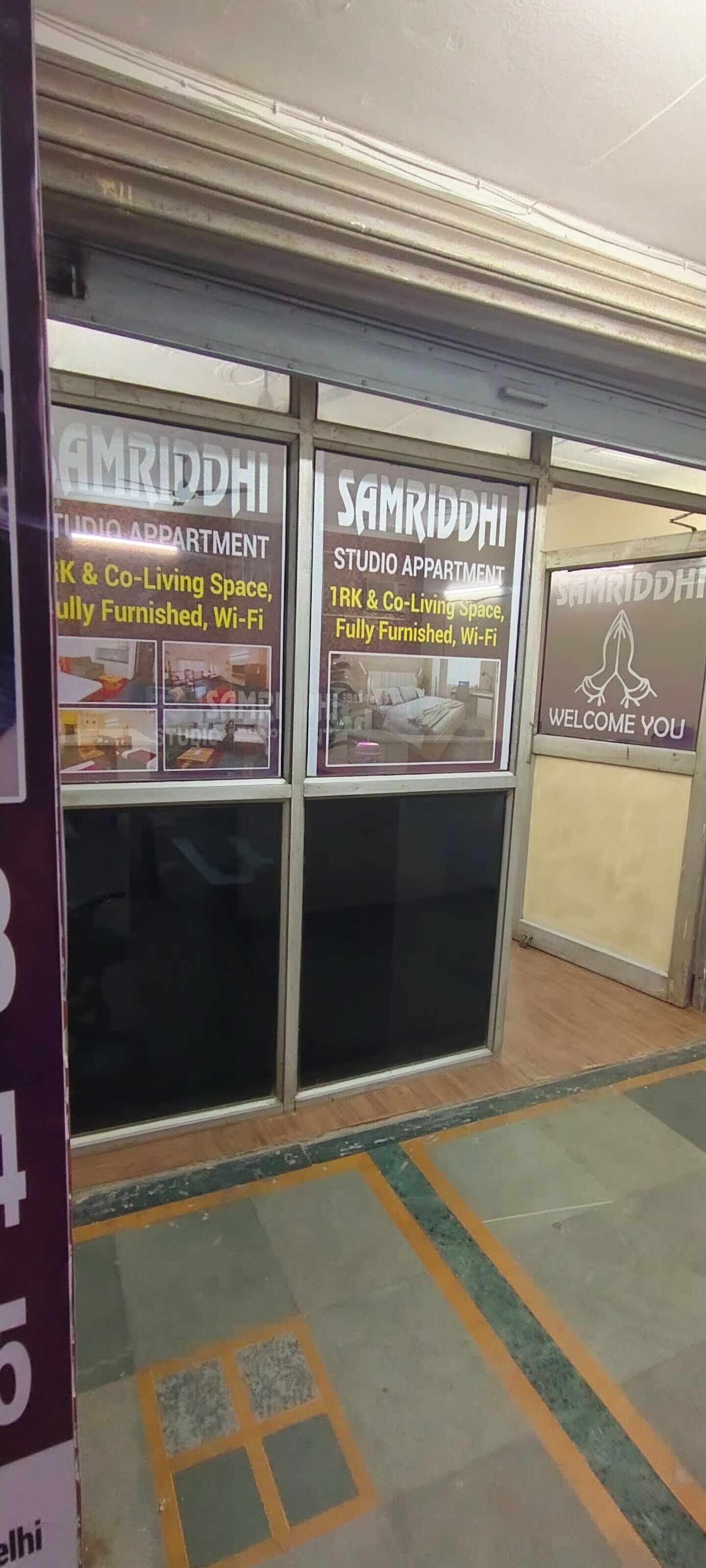 A studio apartment with a signboard advertising it as fully furnished and Wi-Fi enabled.