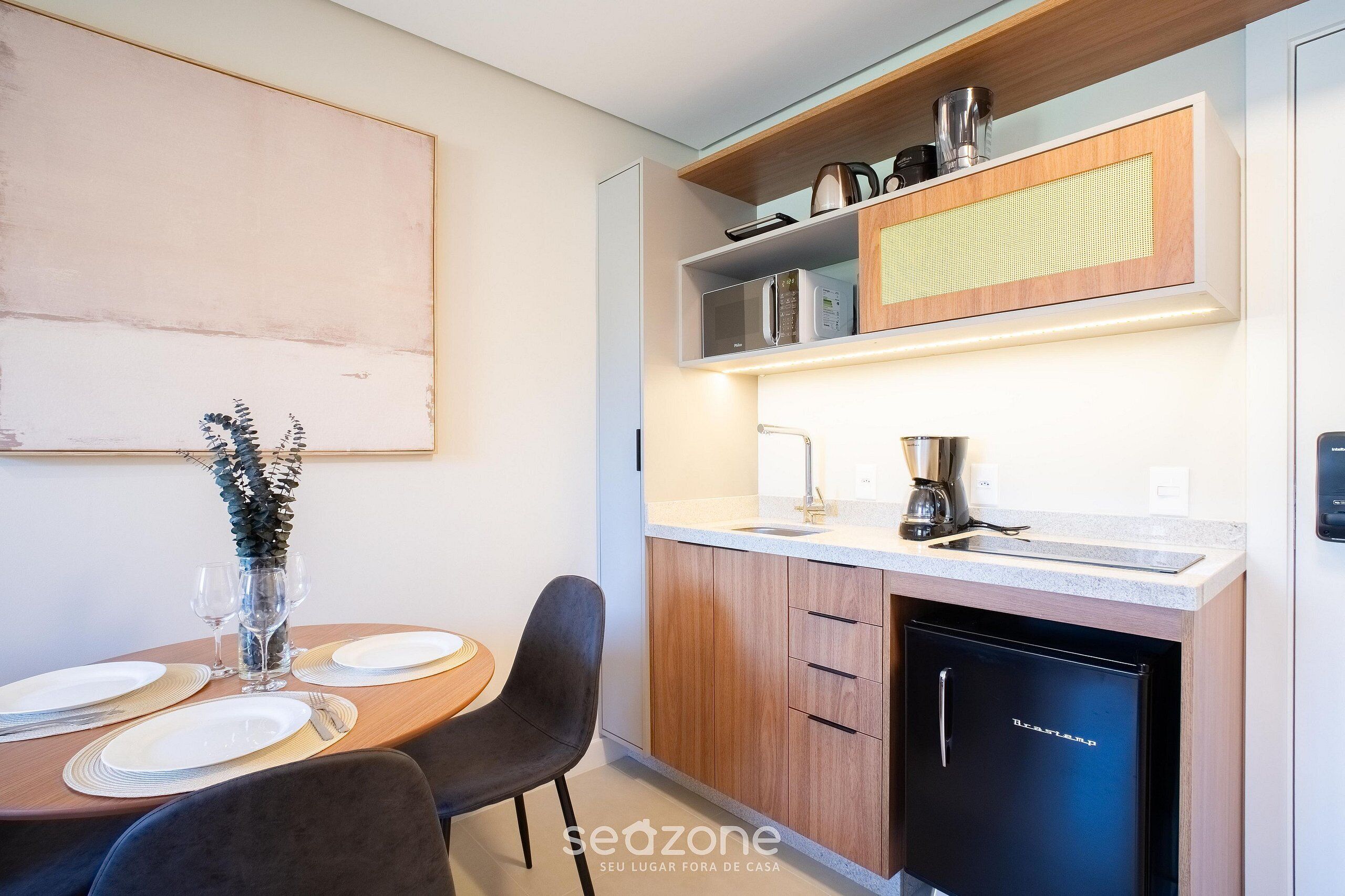 A modern kitchen with a built-in microwave, coffee machine, and dishwasher.