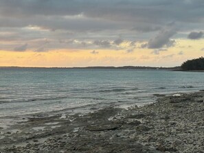 A beach with rocky shoreline and calm water. - Cozy, comfortable 1-bedroom apartment in charming Eleuthera near to the beach. (North Eleuthera)