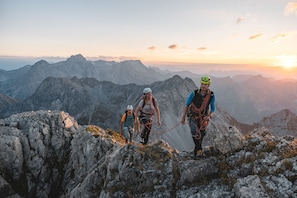A mountainous landscape with rocky terrain and a sunset in the background. - Appartement Borealis (Sankt Gallenkirch)