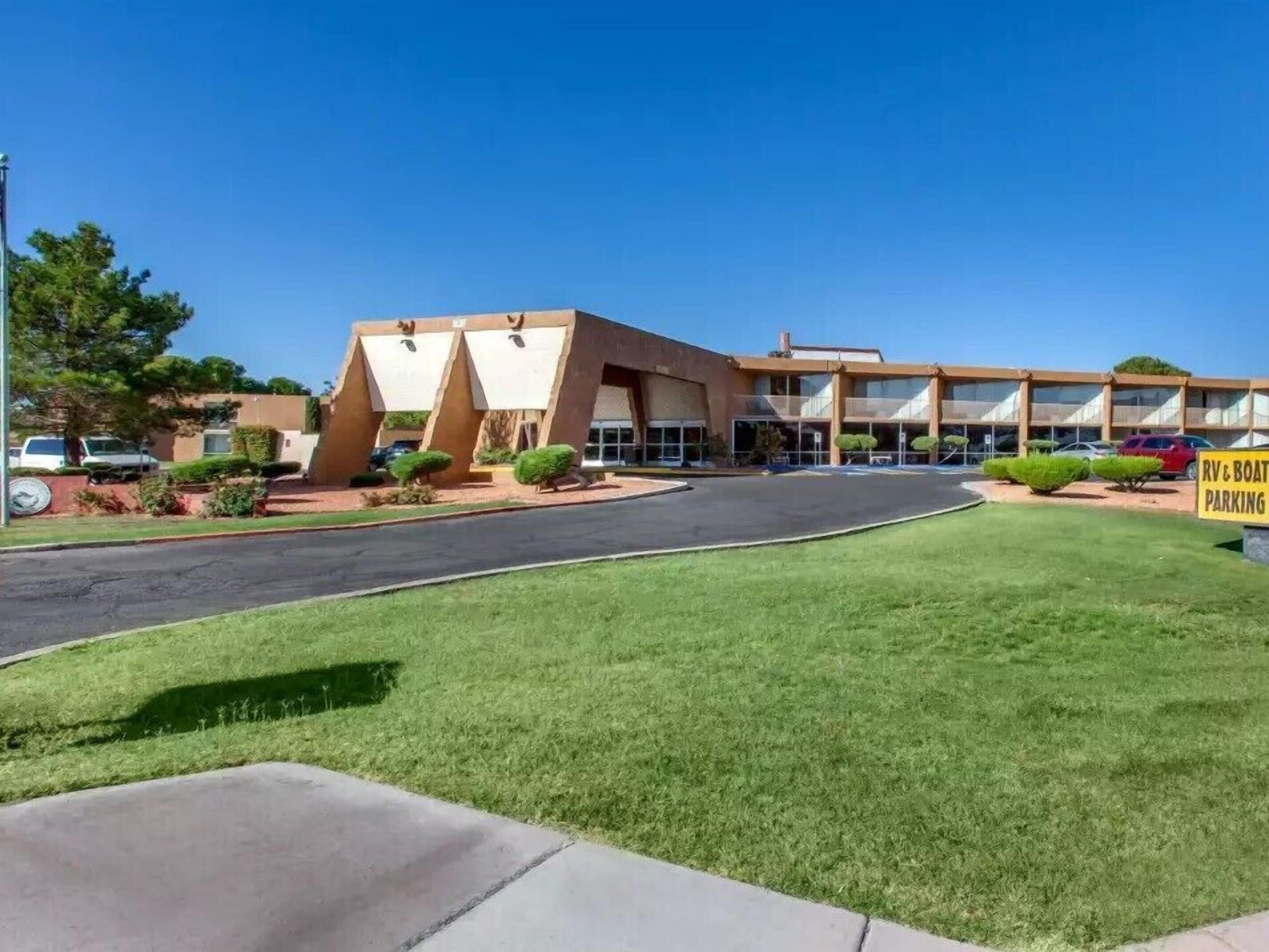 A building with a parking lot, a grassy area, and a sign indicating RV & boat parking.