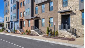 A row of modern multi-story residential buildings with brick facades, uniform windows, and small front steps leading to the entrances. - Delightful balti, Washington DC retreat (Laurel)