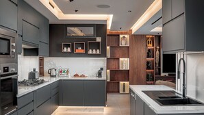 A modern kitchen with dark cabinetry, a large island, and built-in appliances. - Oriental chic • 3 bedrooms with private pool and spa (Marrakesh)
