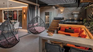 A modern interior with hanging chairs, a sofa, and a dining area. - Oriental chic • 3 bedrooms with private pool and spa (Marrakesh)