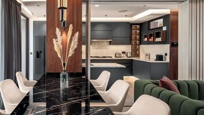 A modern kitchen with dark cabinets, a marble countertop, and a built-in oven. - Oriental chic • 3 bedrooms with private pool and spa (Marrakesh)
