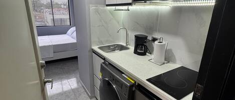 Fridge, microwave, coffee/tea maker, cookware/dishes/utensils