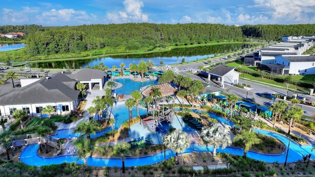 A resort with multiple swimming pools, a water park, and a lake view. - 5BR 5BA Home Storey Lake Water Park Amenities (Kissimmee)